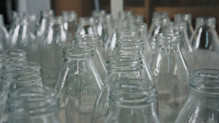 Many empty glass bottles waiting to be filled in