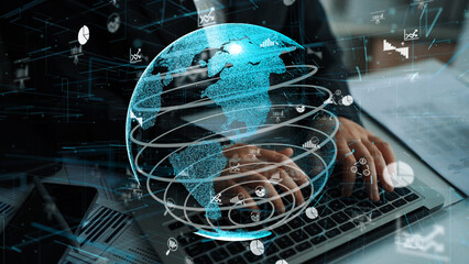 A striking digital image representing global connectivity and analytics, showcasing a glowing globe overlaid on a person typing on a laptop in a modern office setup. Xenic