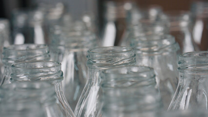 Empty glass bottles awaiting filling in industrial
