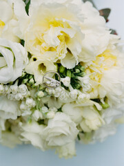 Elegant wedding rings nestled in delicate white flowers at a beautiful bridal bouquet display