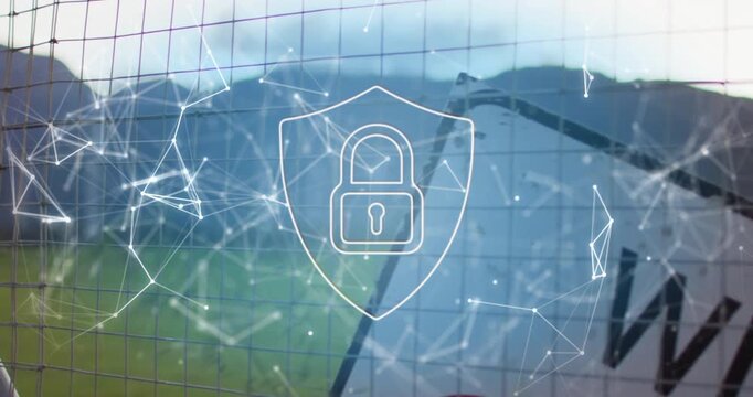 Slow camera panning goal net revealing field while data network shielding padlock protecting assets