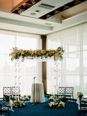 Beautiful wedding ceremony setup with floral arch and elegant decor overlooking the water