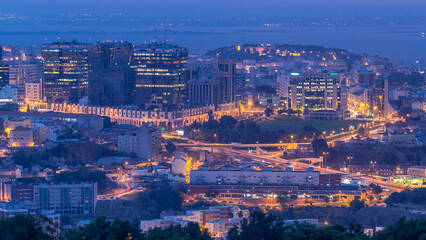 Panoramic view over Lisbon and Almada from a viewpoint in Monsanto night to day timelapse.