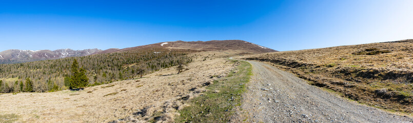 Panoramic view of idyllic mountain landscape in Austria. Smooth mountains with hiking trail at Hochrindl pasture.