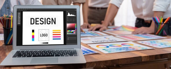 Graphic designer software for modern design of web page and commercial brisk ads showing on the computer screen