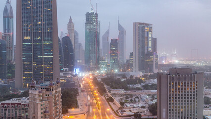 Dubai downtown skyline night to day aerial timelapse with traffic on highway
