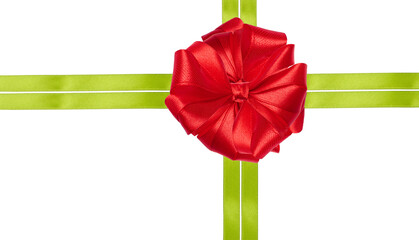 A bright red bow is placed in the center of a composition of two intersecting green satin ribbons on an isolated background.