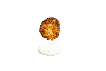 a fried potato cake and a bowl of sour cream