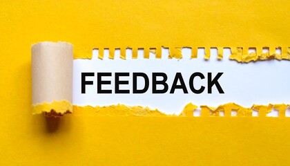 Ripped yellow paper revealing the word FEEDBACK
