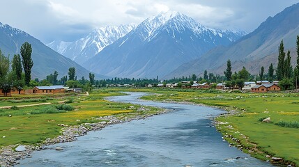 Lush valley with a river flowing through a village nestled beneath snow-capped mountains.