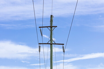 Photograph of the top cable section of an old style wooden electricity transmission line support pole typically used in regional parts of Australia.