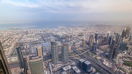 Fototapeta premium Downtown of Dubai in the morning timelapse after sunrise. Aerial view with towers and skyscrapers