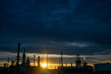 Obraz premium Sunset silhouettes at oil refinery Detroit Michigan 