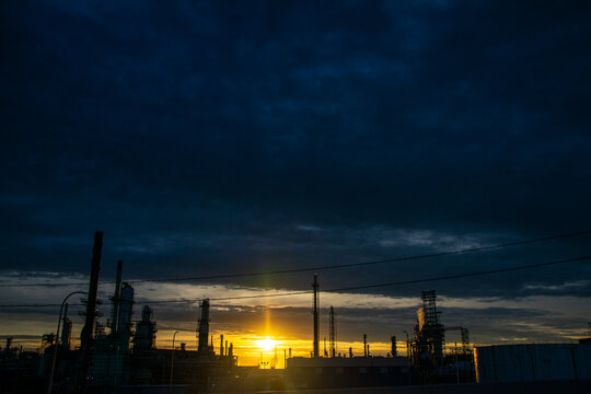 Sunset silhouettes at oil refinery Detroit Michigan 