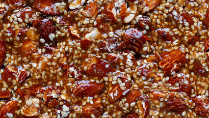 Background texture of typical Christmas dessert -nougat with almonds and sesame seeds (Spanish turron).