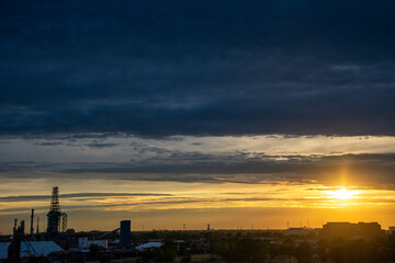 Sunset silhouettes at oil refinery Detroit Michigan 