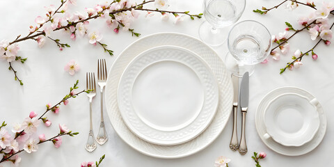 Elegant white table setting with peach blossoms overhead