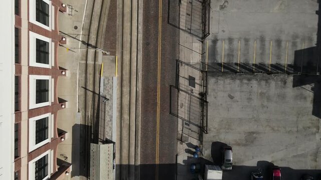 Drone flies east in bird's eye view over E 8th Avenue in Ybor City, Tampa, Florida, USA