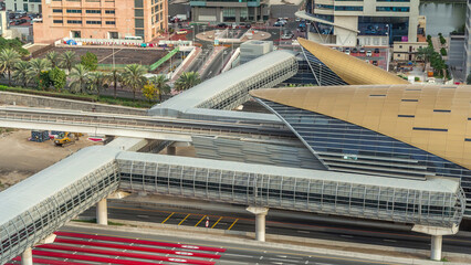 Obraz premium View to metro station near Dubai Marina and JLT with traffic on sheikh zayed road aerial timelapse