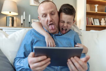 Selfie, picture and father with funny face on sofa, smile and funny for social media comedy. Photography, memories and dad with child in home living room, bonding and happy for goofy fun with family.