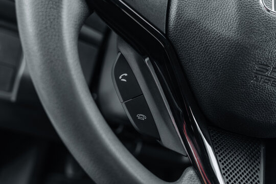 Close-up of Honda steering wheel with integrated menu navigation buttons and chrome trim – automotive interior detail showcasing control functionality, tactile design and ergonomic driving features