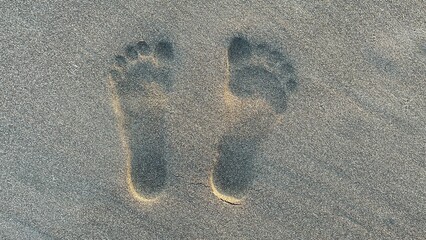 Footprints on Sandy Beach Surface