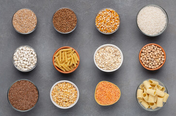 Set of healthy grains and noodles full of carbohydrates on gray background