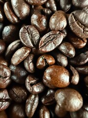Macro shot of roasted coffee beans. Rich brown tones and detailed texture for food, beverage, and caffeine-related visuals.
