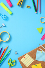Flat lay frame of school supplies on a blue background