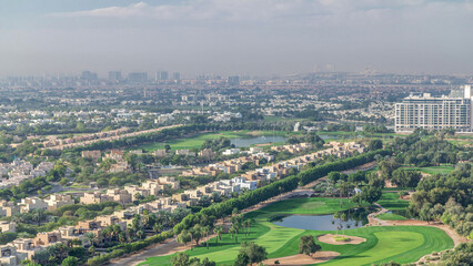 Aerial view to villas and houses with Golf course with green lawn and lakes timelapse