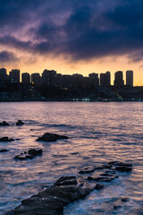 The dramatic twilight view of Concon, Chile, showcasing its urban development along the coast with a colorful sky.