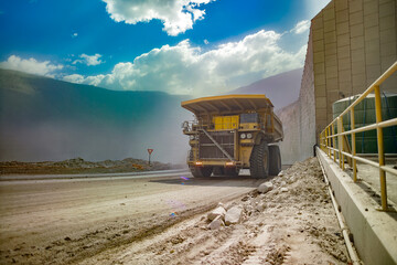 The sheer scale of a Chilean open-pit copper mine, featuring a huge haul truck under a dramatic sky.
