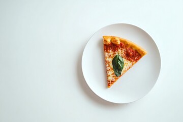 Overhead view of a single slice of margarita pizza garnished with basil leaves, served on a white plate against a minimalist white background
