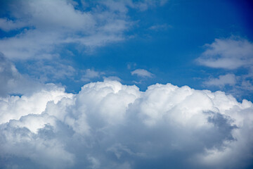  Fluffy white cloud in a vivid clear blue sky on a sunny day