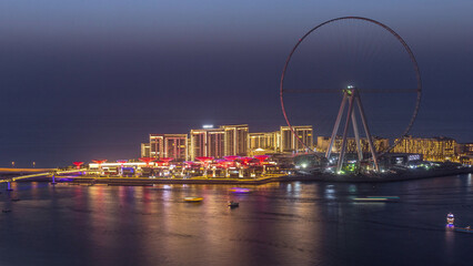 Obraz premium Bluewaters Island in Dubai aerial day to night timelapse after sunset.