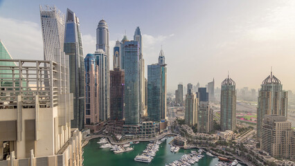 Aerial top view of Dubai Marina morning timelapse. Modern towers and traffic on the road