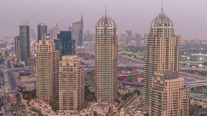 Obraz premium Aerial top view of Dubai Marina day to night timelapse. Modern towers and traffic on the road
