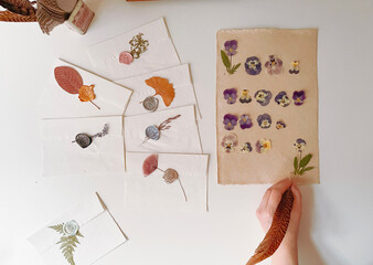 hand holding a notebook with flowers, 