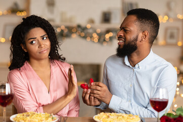 Proposal Fail. Portrait of unhappy african american man proposing to his gilfriend, holding open...
