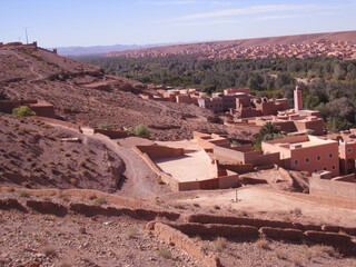 Aït Benhaddou, a traditional desert village in Morocco, featuring earthen clay houses and palm...