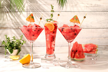 Modern still life with alcoholic cocktail of watermelon, apricot lemon, ice, tequila, vodka and...
