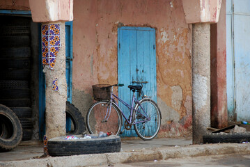 A close-up view of the entrance door to a traditional Bedouin house, featuring rustic materials and...