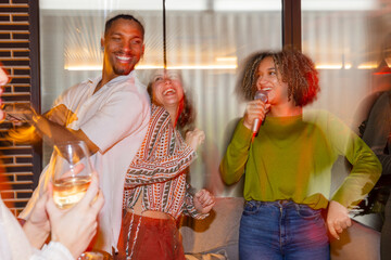 Friends singing and dancing at a lively social gathering