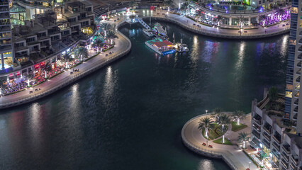 Waterfront promenade in Dubai Marina aerial night timelapse. Dubai, United Arab Emirates