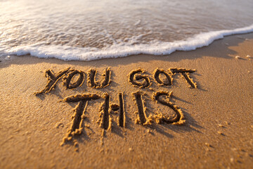 Fototapeta premium Motivational Scene of YOU GOT THIS Written in Wet Sand with Ocean Foam at the Base in Clean Horizontal Layout