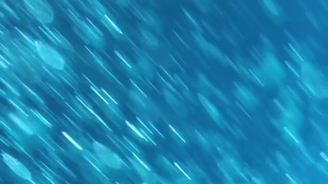 Abstract underwater background. Blurry water texture with fast moving bubbles. Sunlight shinning through blurry bubbles creating lights effect