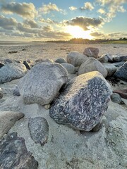 Stones arranged in a line against sunset on Foehr