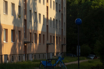 A bicycle is securely parked in front of a large building, showcasing the urban landscape of the...