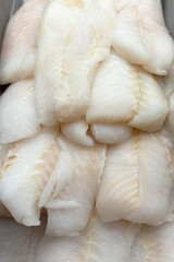 Fresh raw Blue Catfish fish fillets on a fishmongers stall
