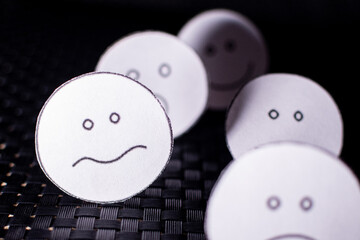 Round papers with emotional faces.